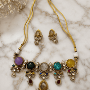 Gold-tone statement necklace with colorful bead drops and matching stud earrings