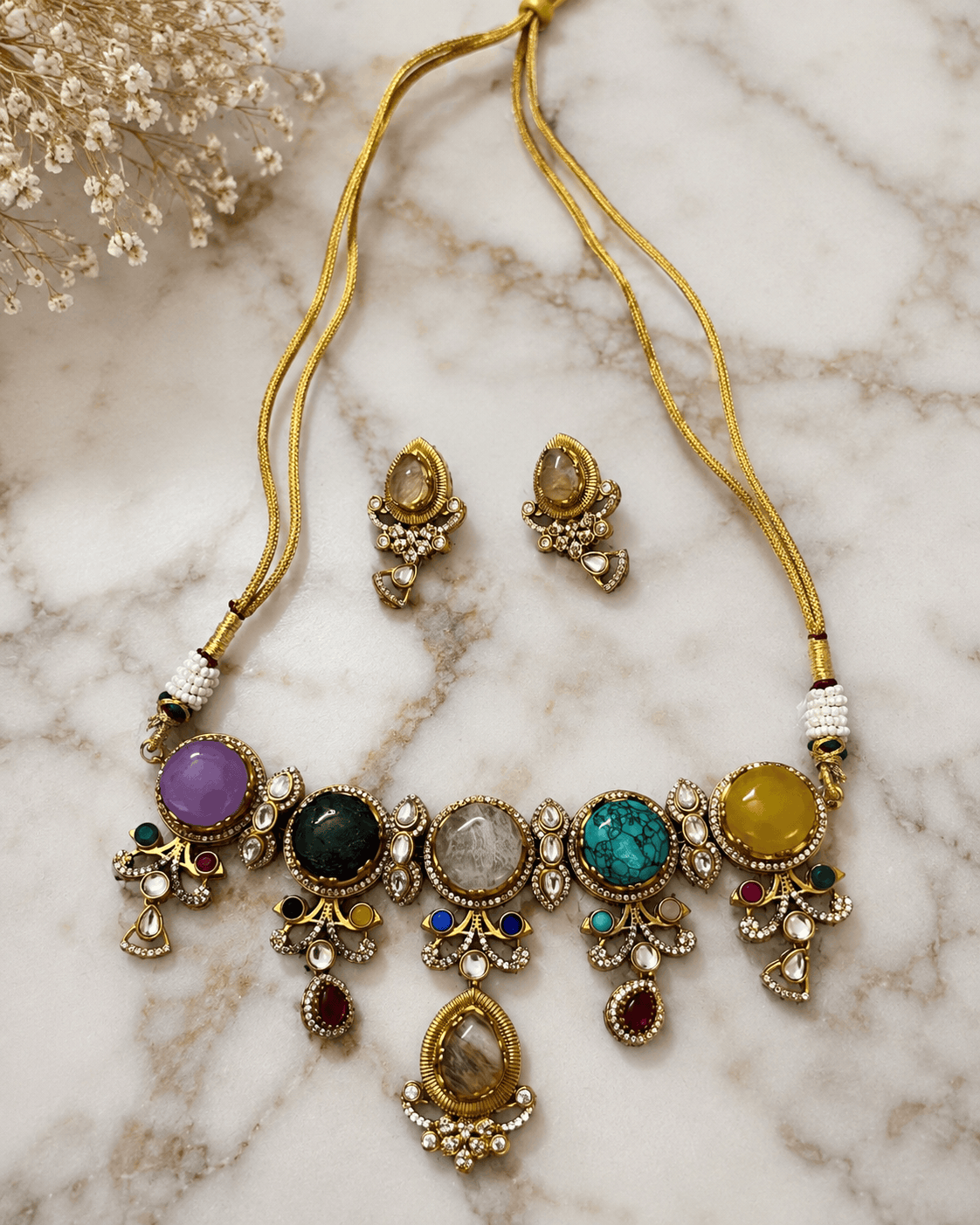 Gold-tone statement necklace with colorful bead drops and matching stud earrings