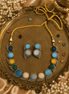 Multicolor beaded stone necklace set with matching earrings, gold-tone accents