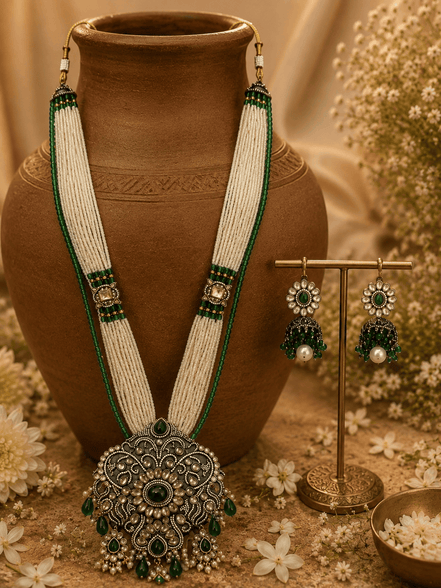 Emerald green beaded necklace set with circular pendant and drop earrings on display