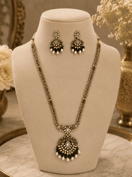 Gold-tone necklace set with emerald-green beaded pendant and matching drop stud earrings