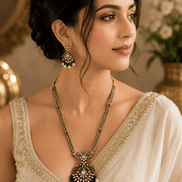 Gold-tone necklace set with emerald-green beaded pendant and matching drop earrings