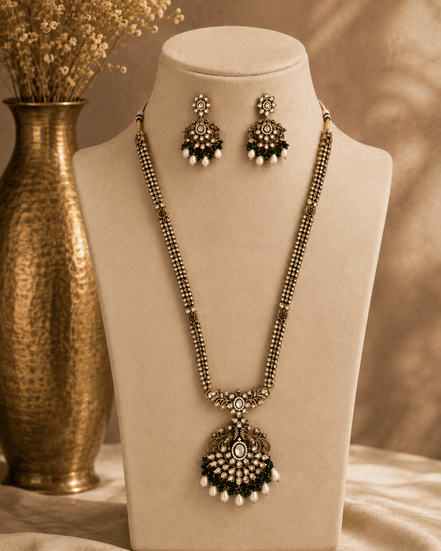 Gold-tone necklace set with emerald-green beaded pendant and matching stud drop earrings