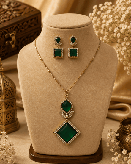 Gold pendant necklace set with emerald green square and teardrop drop accents