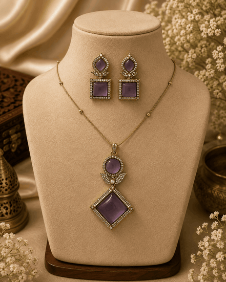 Gold pendant necklace set with purple square earrings and marquise diamond pendant