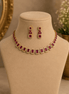 Gold-tone necklace with red and green square stones and matching stud earrings