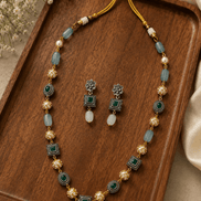 Gold-tone mala necklace with teal square charms and matching stud earrings, set