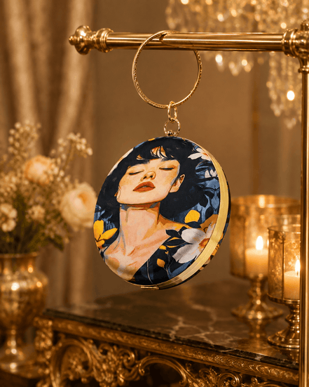 Round blue illustrated clutch bag with gold-tone chain and portrait front