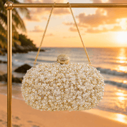 White pearl beaded oval clutch with gold-tone top clasp and hanging chain