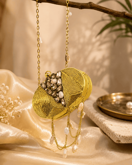 Gold round clutch with crystal beading, textured front, and dangling pearl chain