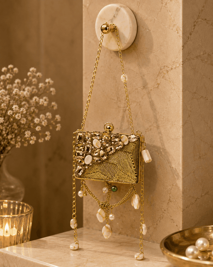 Gold beaded rectangular clutch bag with textured panel, pearl drops, and long chain