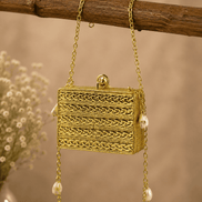 Gold textured rectangular clutch with decorative beading and dangling pearl chain