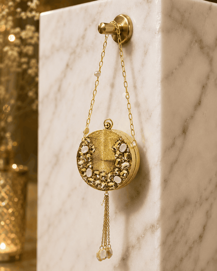 Gold round beaded clutch with pearl tassel chain and textured front panel