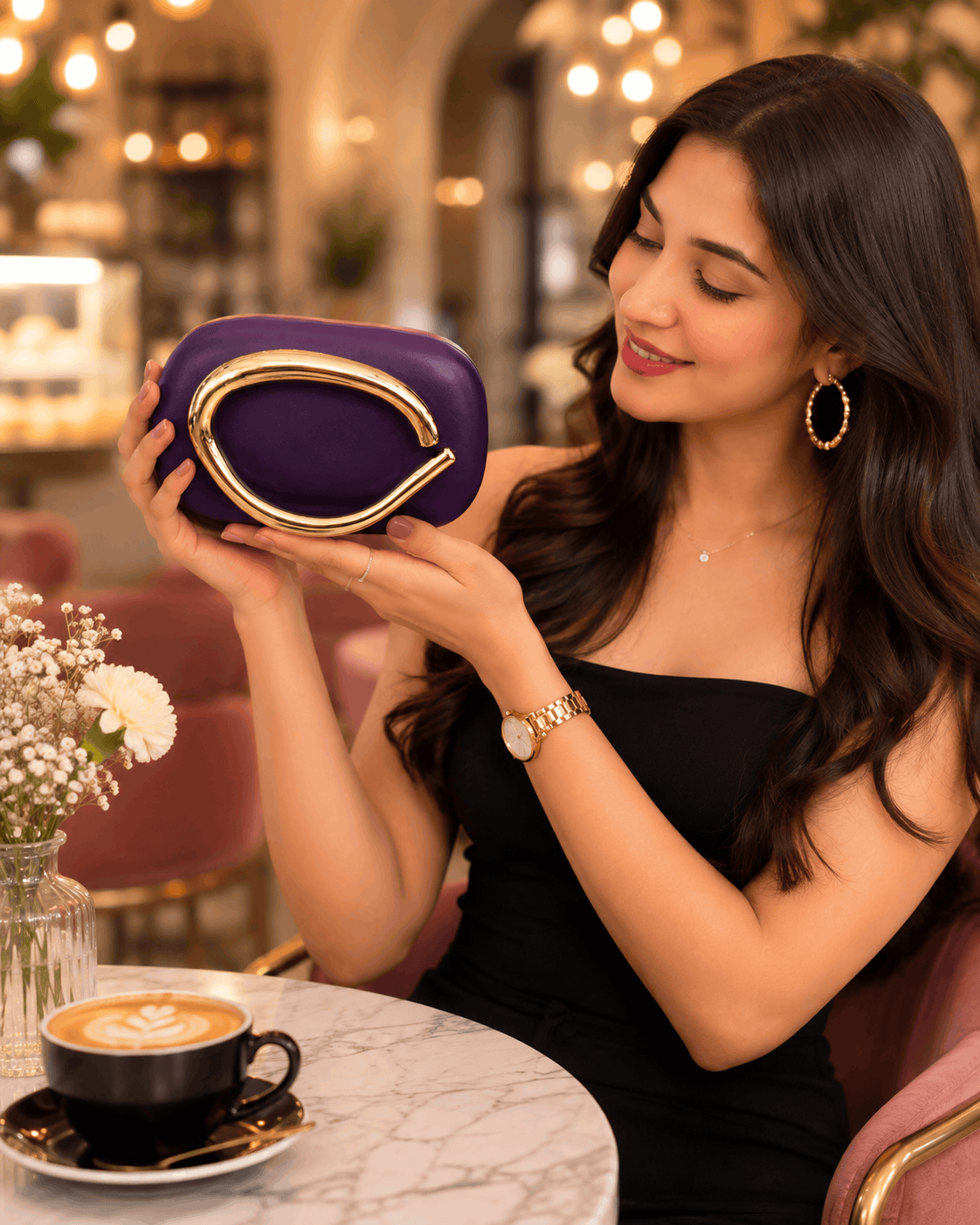 Purple sculptural handle clutch bag with gold-toned frame clasp.
