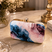 Alora Clutch with marbled blue and pink pattern, gold-tone clasp and frame.