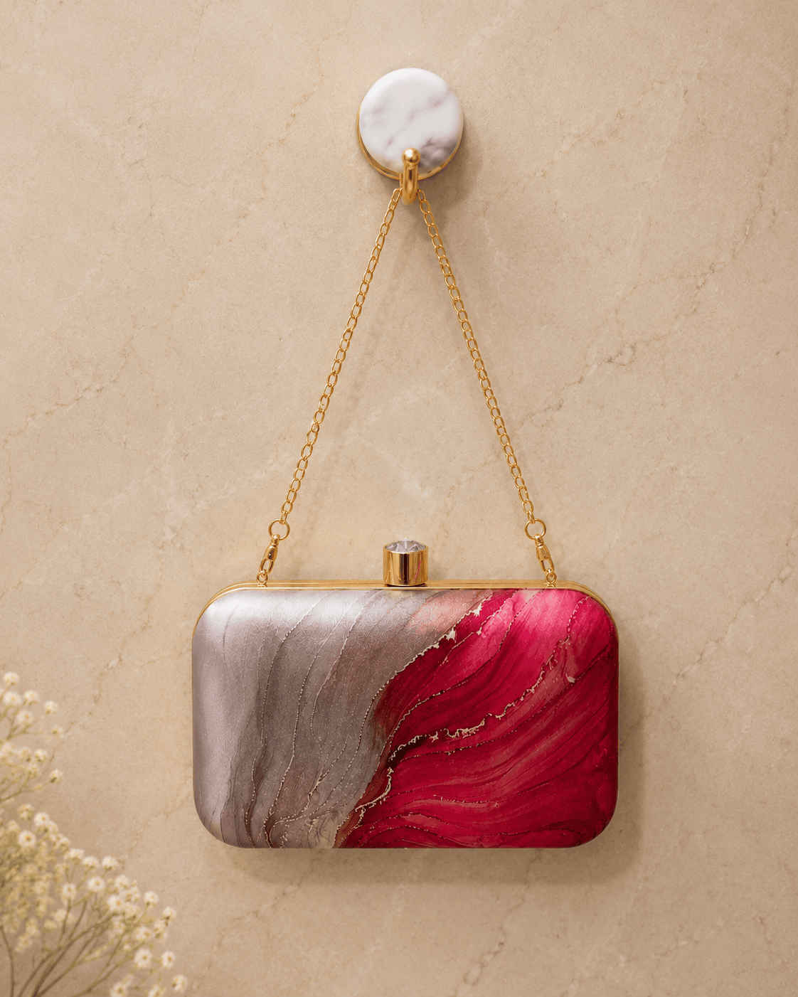 Alora clutch with gold chain strap, gold clasp top, pink and red marble print.