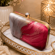 Alora clutch with gold-tone frame and clasp, red and pink marble print.