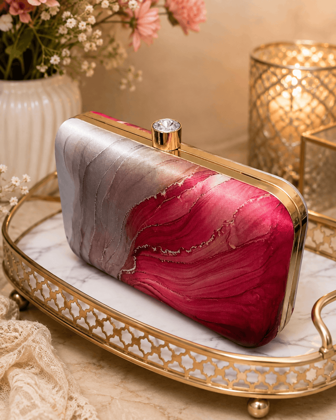 Alora clutch with gold-tone frame and clasp, red and pink marble print.