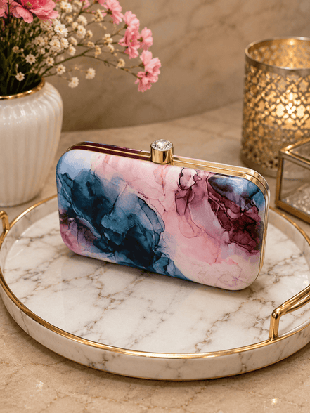 Alora clutch with gold-tone frame and clasp, pink and blue marble print.