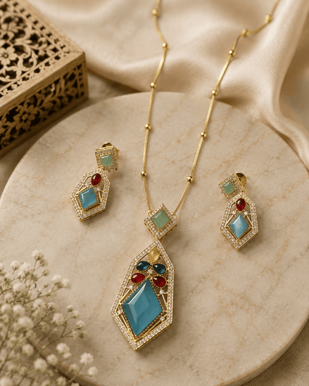 Gold-tone pendant necklace set with teal and red gemstone drop earrings