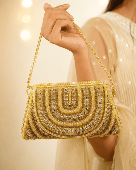 Gold beaded shoulder bag held by chain strap, detailed arched front with fringe