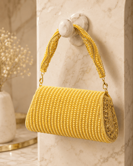 Gold beaded cylindrical shoulder bag with chain handle and tassel fringe