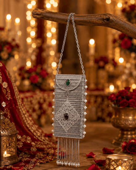 Silver filigree mobile clutch with chain handle, green and purple gem accents