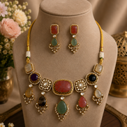 Kundan necklace set on display: gold-tone choker with multicolor stones and dangling earrings