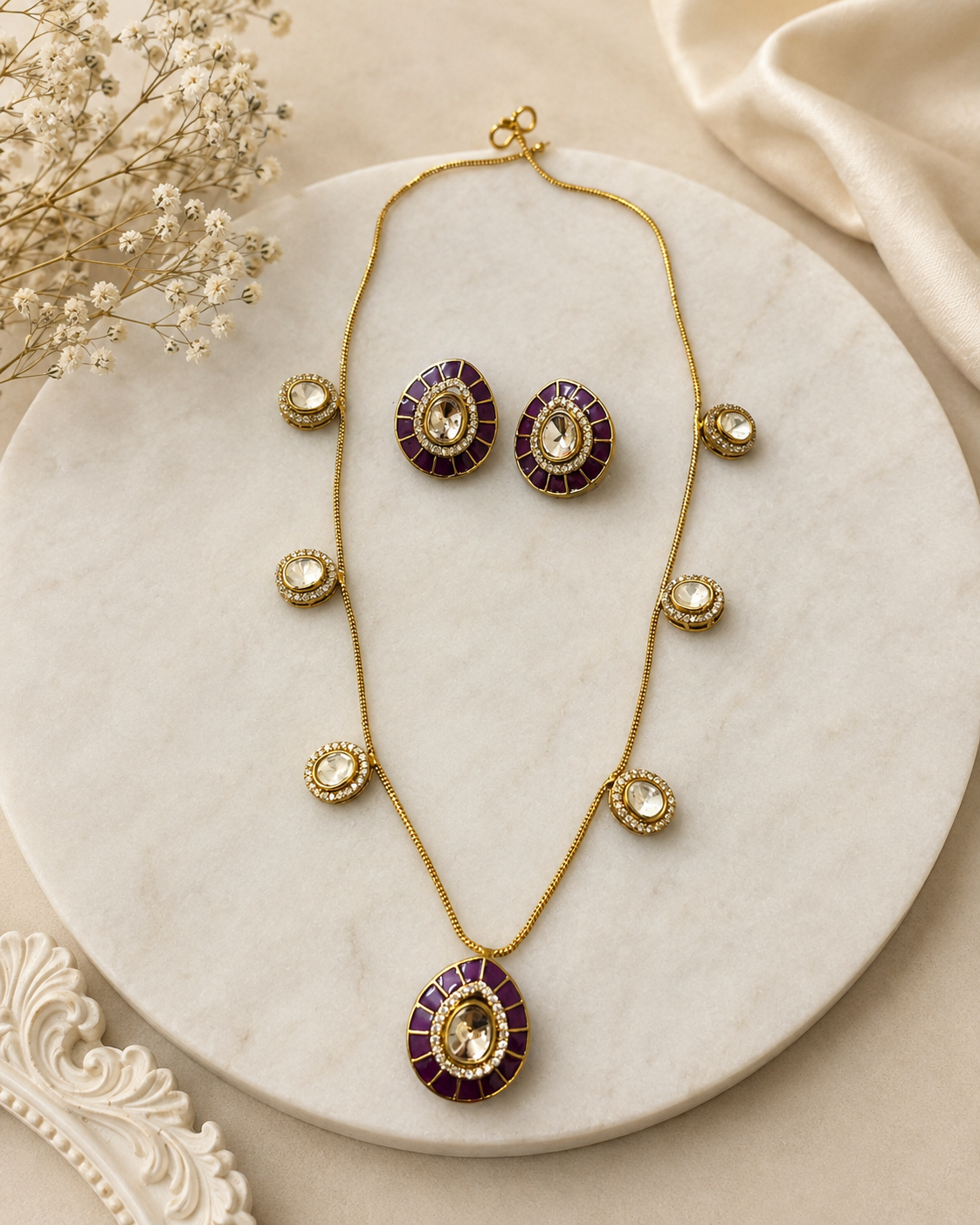 Gold-tone necklace and earring set with round purple center medallions and crystal accents