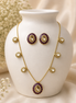 Gold-tone jewelry set: Y necklace with round medallions and matching stud earrings