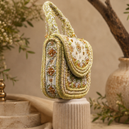 Beige beaded shoulder bag with arched top handle and layered bead trim