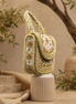 Beige beaded shoulder bag with arched top handle and layered bead trim