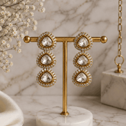 Gold-tone triple drop earrings with teardrop clear stones