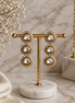 Gold-tone triple drop earrings with teardrop clear stones