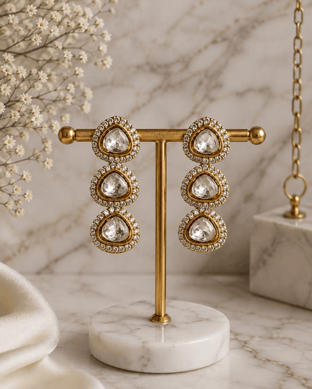 Gold-tone triple drop earrings with teardrop clear stones