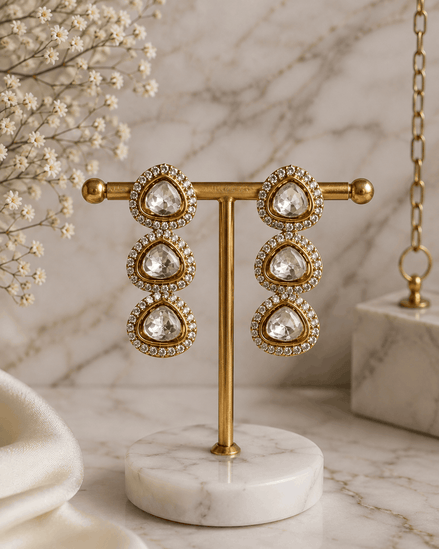 Gold-tone triple drop earrings with teardrop clear stones