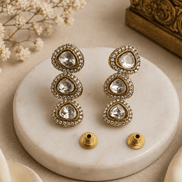 Gold-tone triple drop earrings with three round crystal stones and post backs