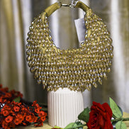 Gold crystal hobo bag with rounded mesh fringe and metal loop handle