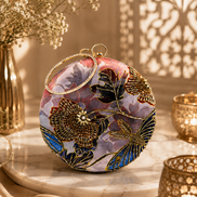 Multicolor circular embroidered ring clutch with gold-toned ring handle, front view.
