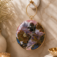 Multicolor embroidered circular ring clutch with gold-toned ring handle and front floral design.