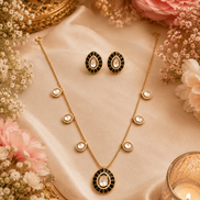 Gold-tone necklace set with black oval pendant and matching oval stud earrings