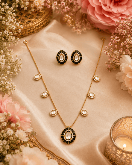 Gold-tone necklace set with black oval pendant and matching oval stud earrings