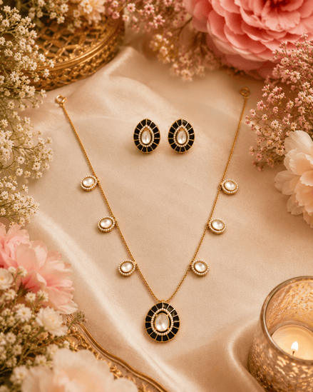 Gold-tone necklace set with black oval pendant and matching oval stud earrings