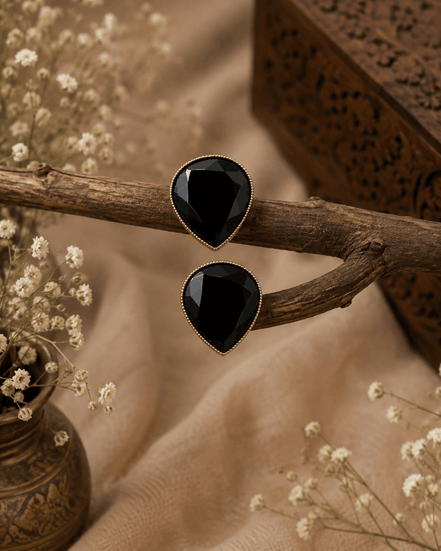 Black teardrop stud earrings with glossy faceted stones