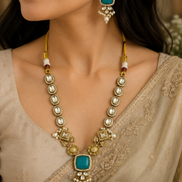 Gold-toned necklace set with teal square pendant and pearl drop earrings