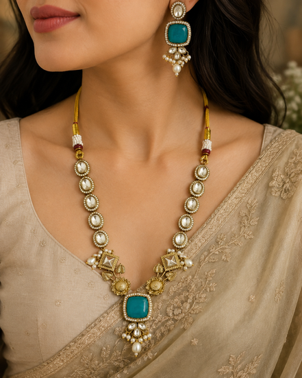 Gold-toned necklace set with teal square pendant and pearl drop earrings
