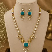 Gold-toned necklace set with teal square pendant and matching round drop earrings