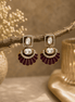 Gold-tone fan statement earrings with oval crystal stones and maroon enamel petals