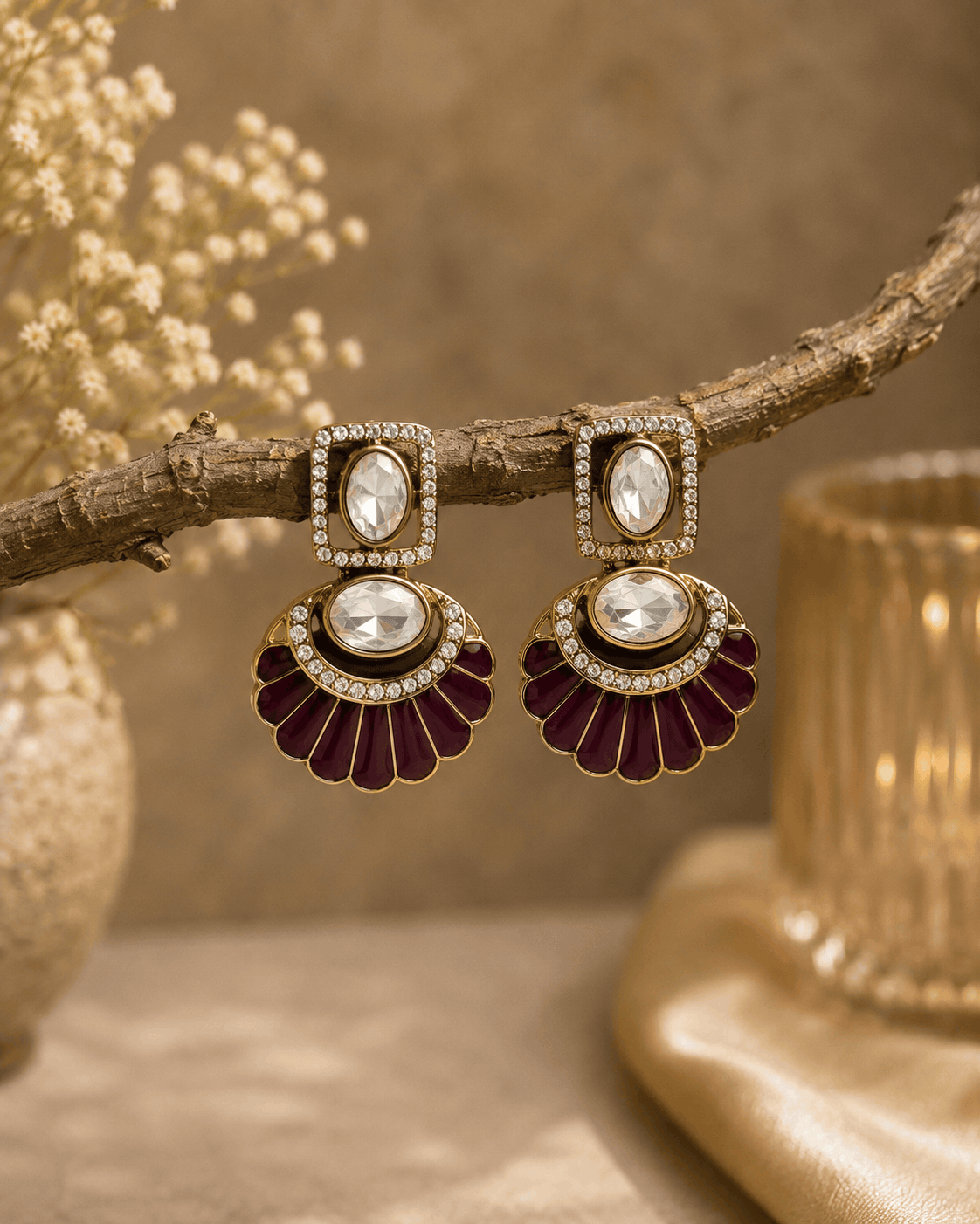 Gold-tone fan statement earrings with oval crystal stones and maroon enamel petals