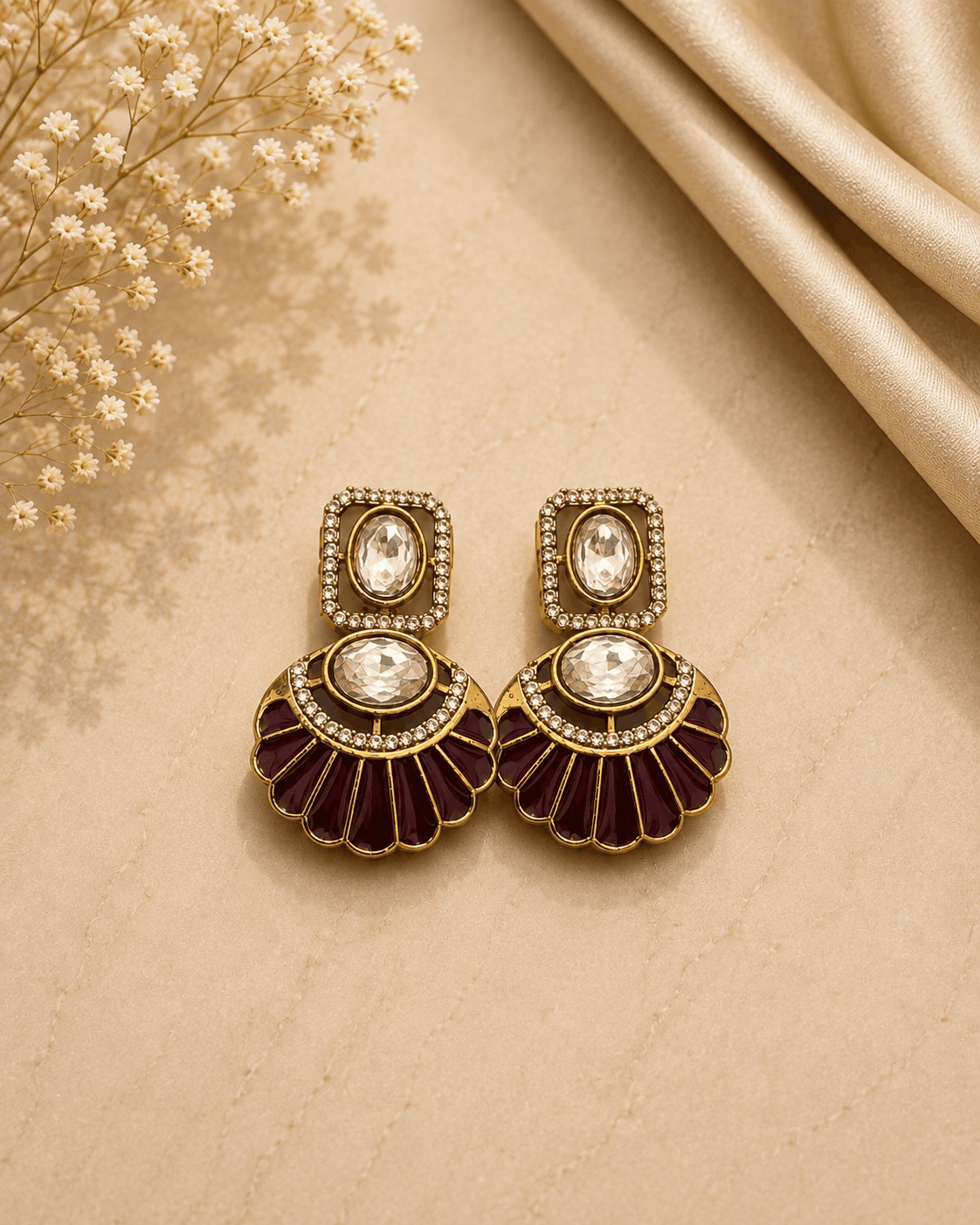 Gold-tone fan earrings with bezel crystal centers and maroon enamel scalloped petals